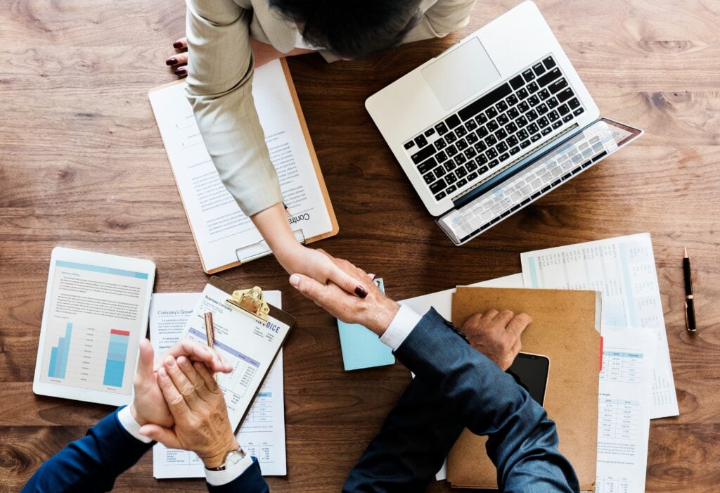 Invest 1 Business people shaking hands together